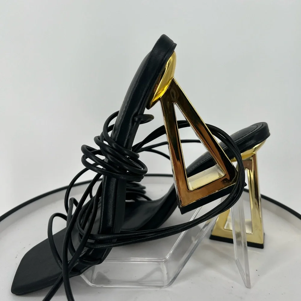 FASHION NOVA STAY WINNING WRAP UP HEELS ‎ IN BLACK GOLD NOVELTY HEELS